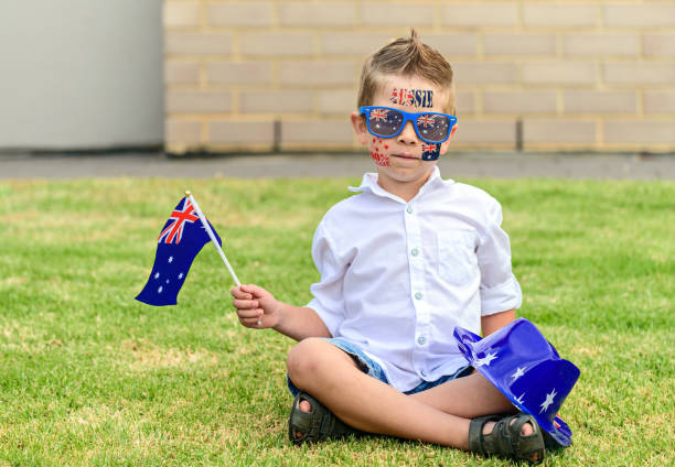 istock Cute boy with Australian flag sitting on front yard on Australia Day 1178766437