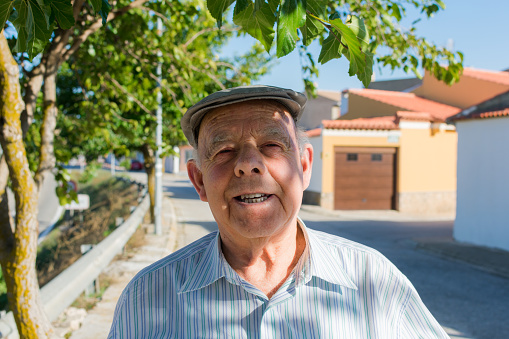 Portrait of a elderly man on the street of a town. Senior, lifestyle