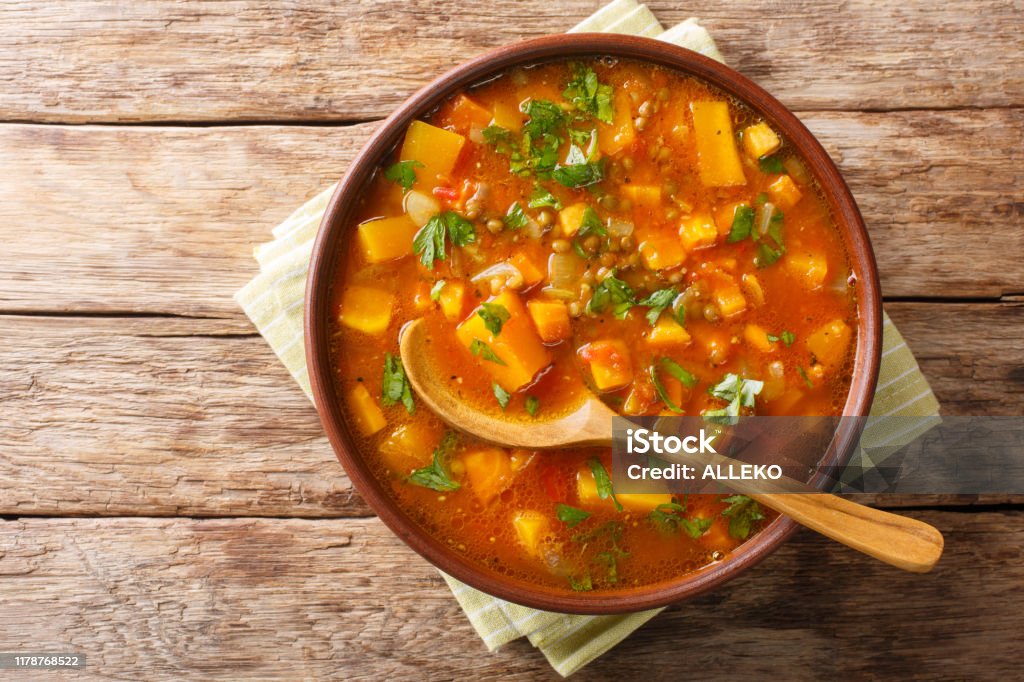 Traditional thick sweet potato soup with lentils close up in a bowl on the table. Horizontal top view Traditional thick sweet potato soup with lentils close up in a bowl on the table. Horizontal top view from above Stew Stock Photo