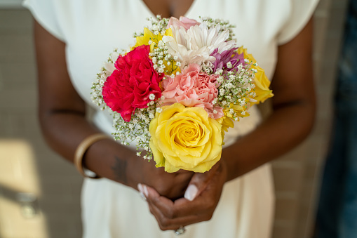 African american female holding flowers
