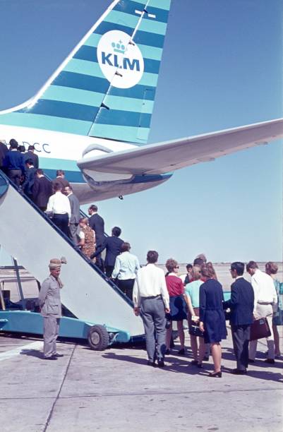 ndia (exact location unknown), 1968. Passengers board a plane on an airfield in India.