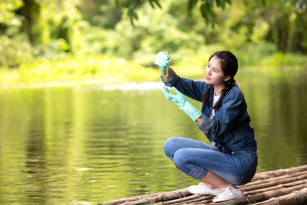 istock Asian student biology taking and testing sample of natural river water.  Experts science women keep water for research analysis in the laboratory.  Environmental pollution Concept 1178769543