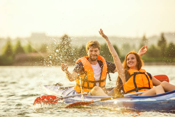 istock Happy couple kayaking on river with sunset on the background 1178769582