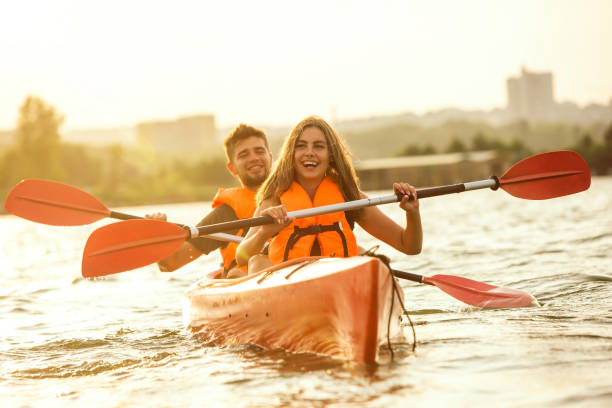 istock Happy couple kayaking on river with sunset on the background 1178769620