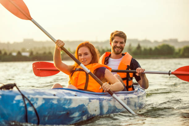 istock Happy couple kayaking on river with sunset on the background 1178769680