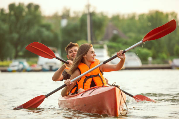 istock Happy couple kayaking on river with sunset on the background 1178769691