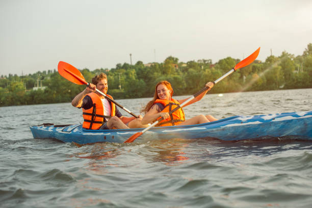 istock Happy couple kayaking on river with sunset on the background 1178769700