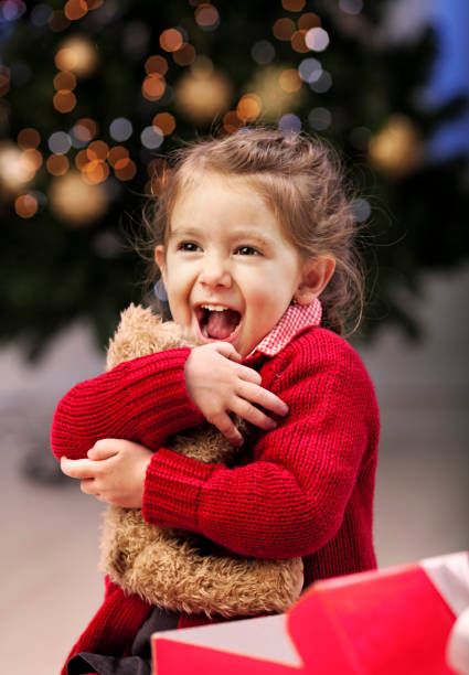 Christmas surprise Little girl excited of the present she have got , it was the same like she wanted  to be ! bear photos stock pictures, royalty-free photos & images