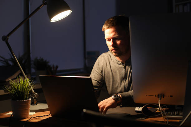 istock Businessman sits in an evenings office at table 1178770154
