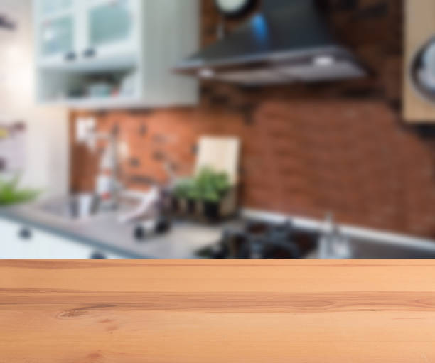 wooden table top and blur kitchen room of the background - domestic kitchen kitchen sink contemporary counter top imagens e fotografias de stock