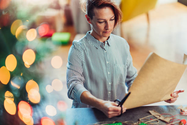 istock Woman preparing to wrap a Christmas presents 1178774596