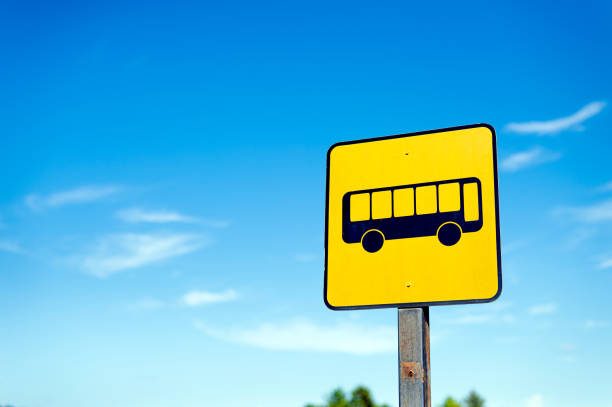 closeup bus stop sign with a blue sky background