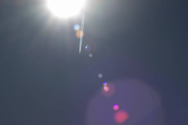 aricraft contrail and  lens flair on summer sky