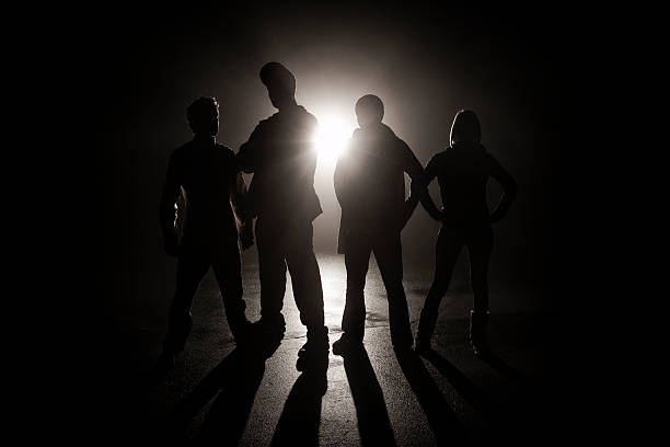 Gang in the shadows  back lit stock pictures, royalty-free photos & images
