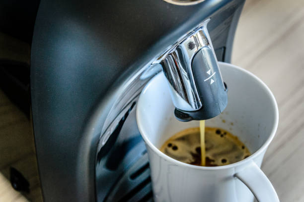 istock espresso coffee maker machine making and flowing out espresso into a white china cup 1178776937