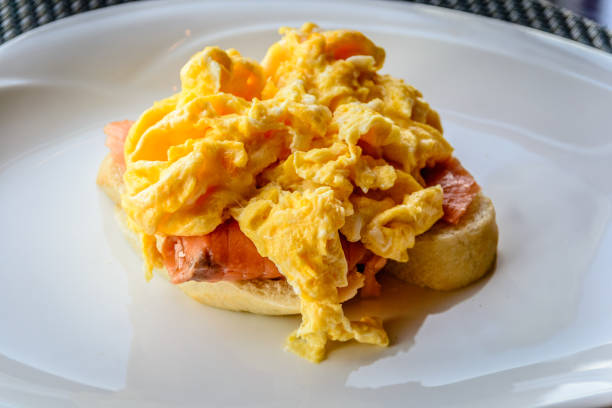 istock scrambled eggs on smoked salmon and baguette served on a white china plate 1178777530