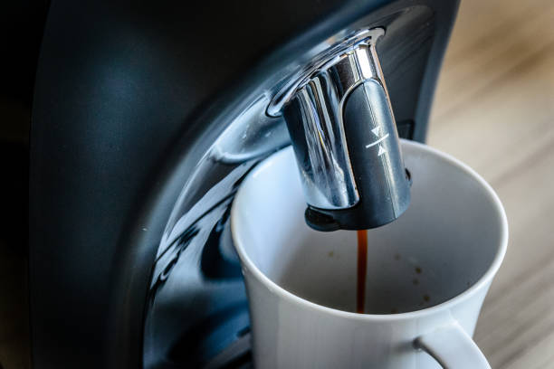 istock espresso coffee maker machine making and flowing out espresso into a white china cup 1178777549