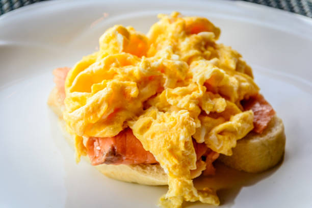 istock scrambled eggs on smoked salmon and baguette served on a white china plate 1178778139