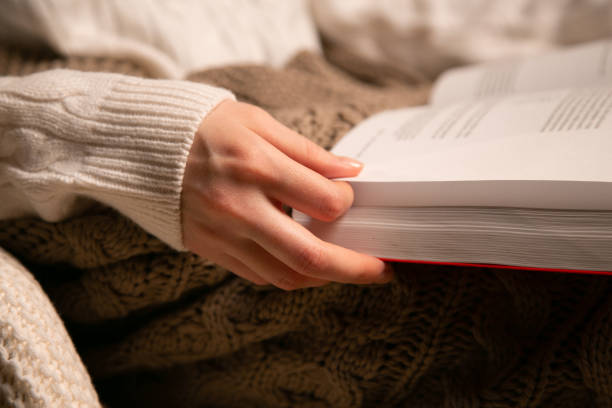 istock Young woman reading a book 1178778870