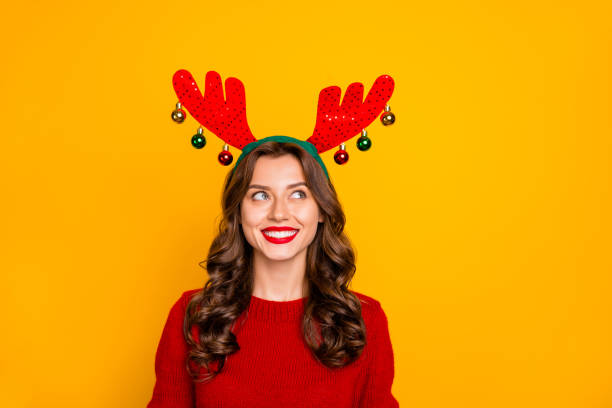 Photo of pretty lady looking on head horns with interest wear knitted jumper isolated yellow background Photo of pretty lady looking on head horns with interest wear knitted, jumper isolated yellow background antler stock pictures, royalty-free photos & images