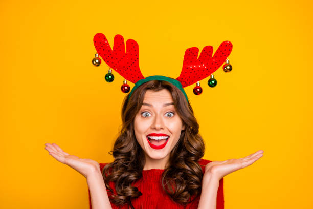 Pretty lady overjoyed with xmas decor wear head horns and knitted pullover isolated yellow background Pretty lady overjoyed with xmas decor wear head horns and knitted, pullover isolated yellow background christmas excitement stock pictures, royalty-free photos & images