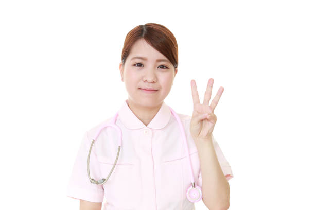 Attractive young female medical professional on magenta background