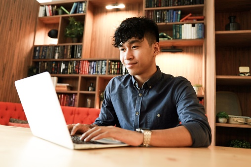 Young asian student is searching job in the library