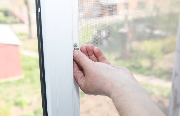 istock Man is installing the mosquito net on the window. Protection from bugs. 1178782083