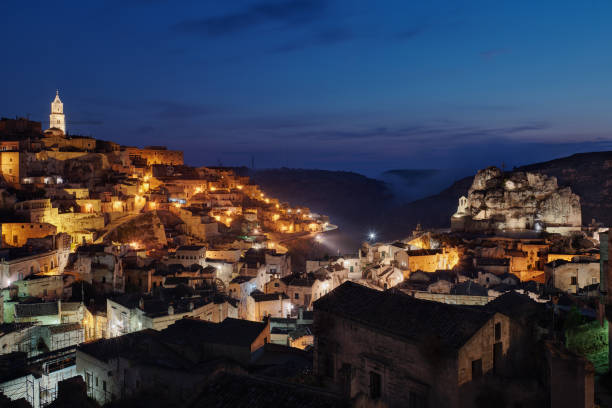 Italy, Basilicata, Matera, Townscape and historical cave dwelling, Sassi di Matera at blue hour stock photo