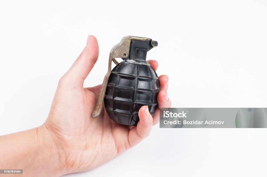 Bomb in hand isolated on white background.Copy space. Bomb in hand isolated on white background.Copy space Hand Grenade Stock Photo
