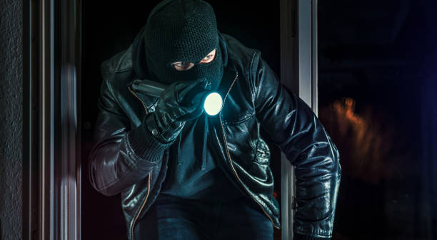 istock masked burglars breaking and entering into a victim's home 1178785201
