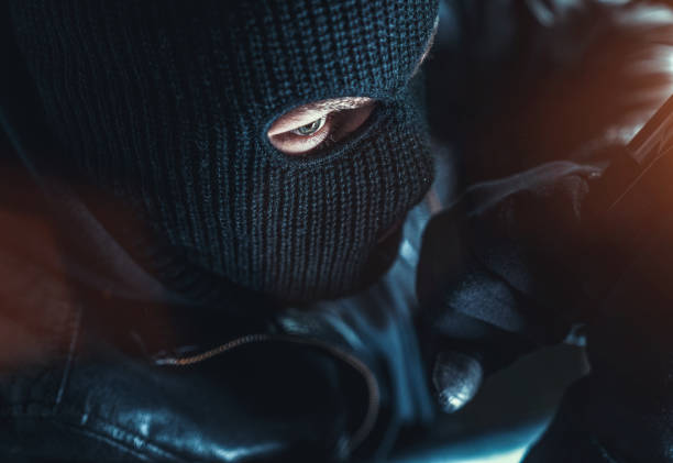 istock masked burglars breaking and entering into a victim's home 1178785220