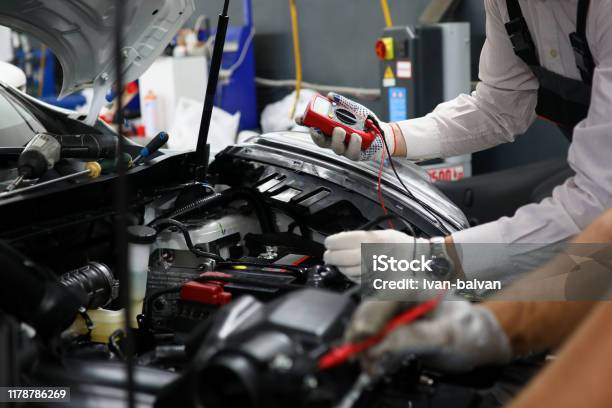 Two Specialists Of Service For Repairing Wiring Stock Photo - Download Image Now - Car, Electronics Industry, Auto Repair Shop