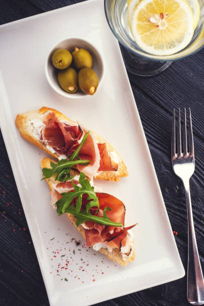 istock Bruschetta with Parma and goat cheese, olives and almonds. Wine set 1178787908