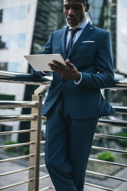 istock Elegant Businessman Working on a Tablet 1178788103