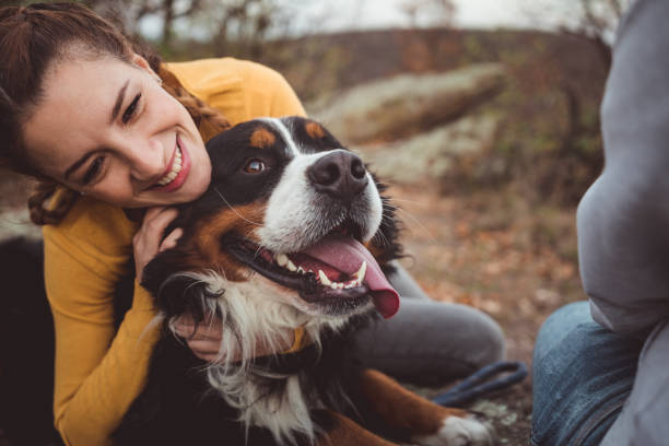 犬を飼っている若い女性 - pets embracing one person portrait ストックフォトと画像