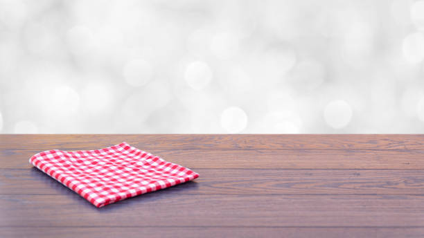 istock Empty wooden table with table cloth over abstract bokeh 1178789145