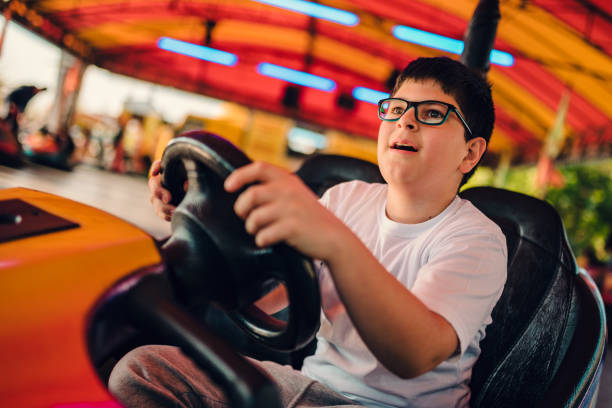 istock Boy driving bumper car in amusement park 1178793754