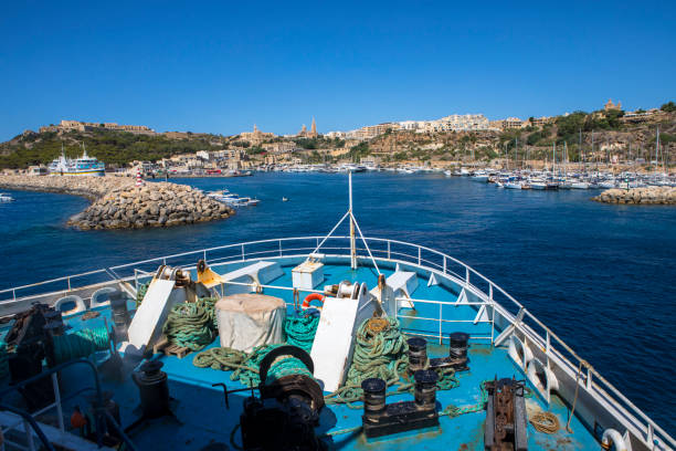 Malta - August 15th 2019: A view from the Gozo Channel Line passenger and vehicle ferry approaching the island of Gozo.