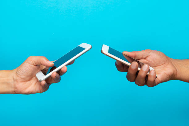 istock Two Hands Holding Mobile Phones 1178798703
