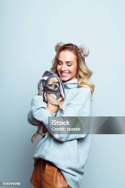 Winter Portrait Of Happy Beautiful Woman Hugging Chihuahua Stock Photo - Download Image Now