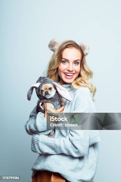 Winter Portrait Of Surprised Beautiful Woman Holding Chihuahua Stock Photo - Download Image Now