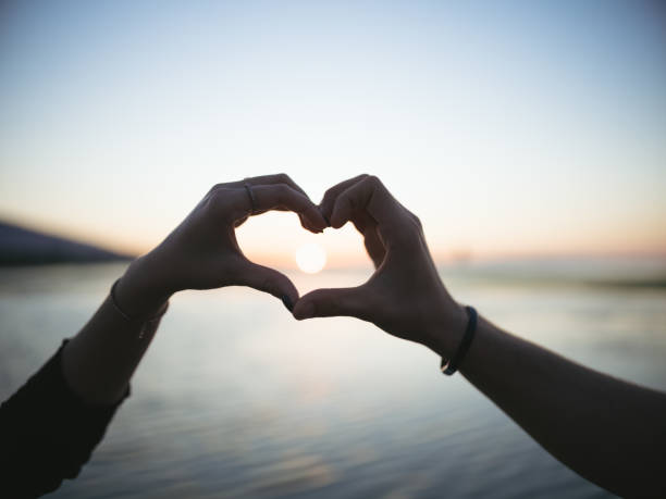 istock couple makes heart symbol at dusk 1178801386