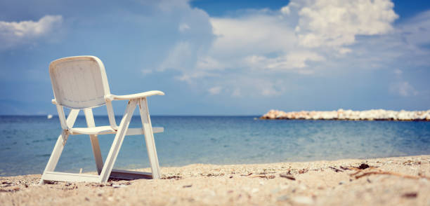 istock Empty beach chair by the sea with stormy clouds in the background 1178802314