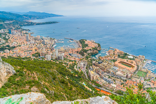 Landscape with view of a coastal city and blue water in the sea from top of a mountain peak, Monte Carlo, Monaco