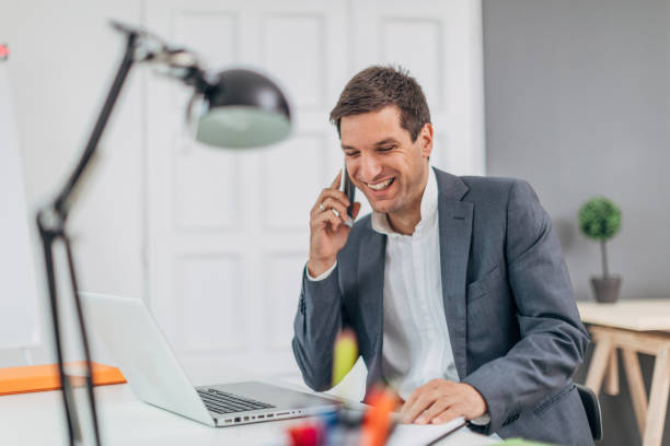istock Cheerful businessman talking on phone 1178803738