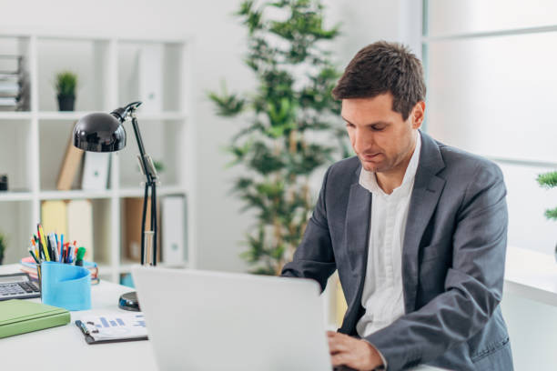 istock Businessman sitting at the office and using laptop 1178804069