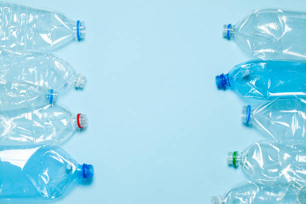istock Crumpled plastic bottles on a blue background. Plastic trash. Copy space for text. 1178805901