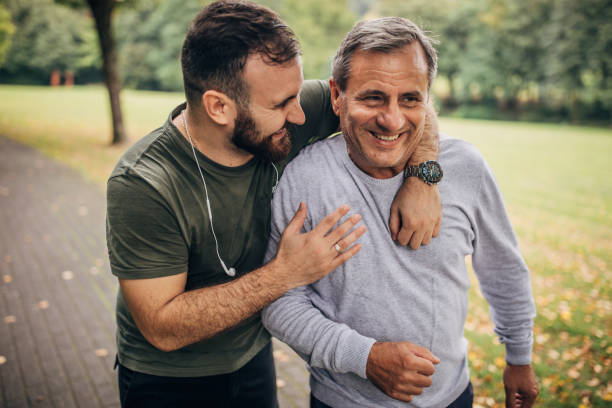istock Father and son jogging in park 1178806114