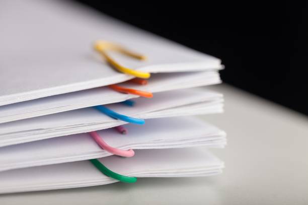 Paper. File folders with documents and bright paperclips document stock pictures, royalty-free photos & images